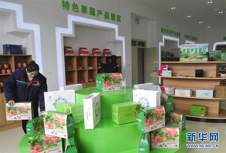 工作人员在海兴县农村电子商务公共服务中心展室内摆放展示的农产品